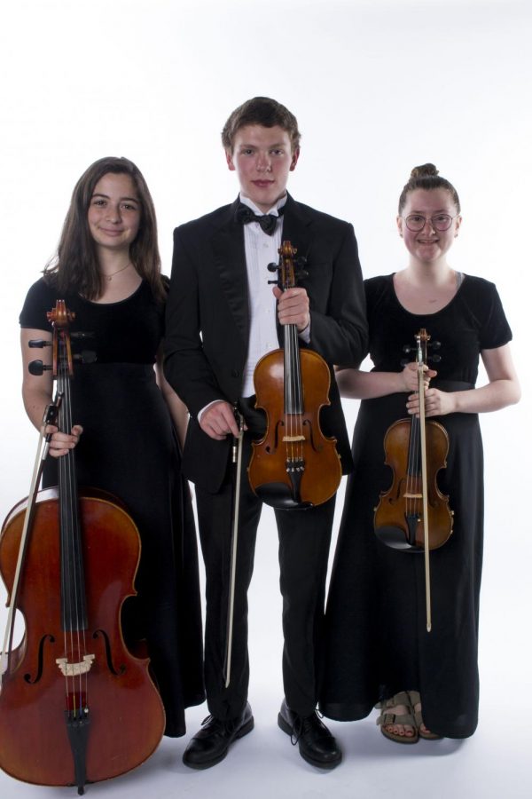 Talia Marshall (12), Joe von Storch (12),  and Margaret Lather (12), all members of the Chestnut Oak String Quartet, pose for a picture. (Sophia Rubin (12) not pictured)