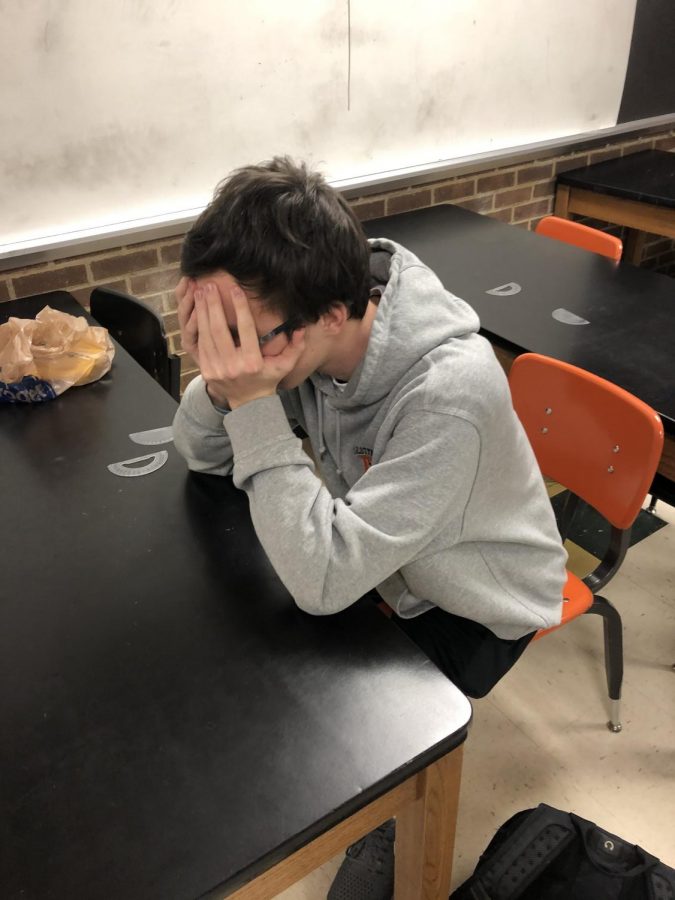 Senior Archer Lyster, a member of the C.H.S. mens lacrosse team, hangs his head in despair over his upcoming test.