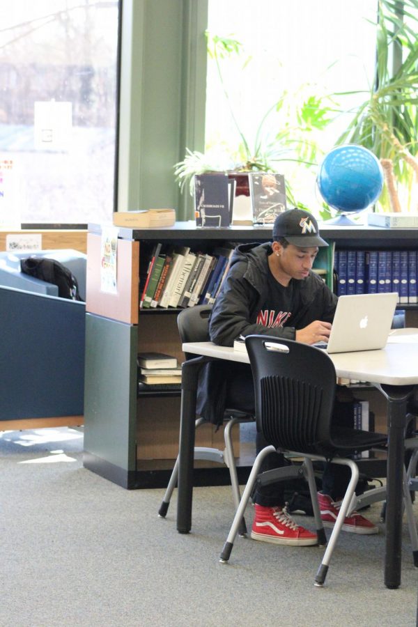 A student hard at work in the library during the week leading up to midterms.