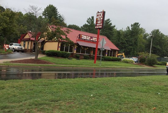 A picture of cookout taken from across the road in the rain.