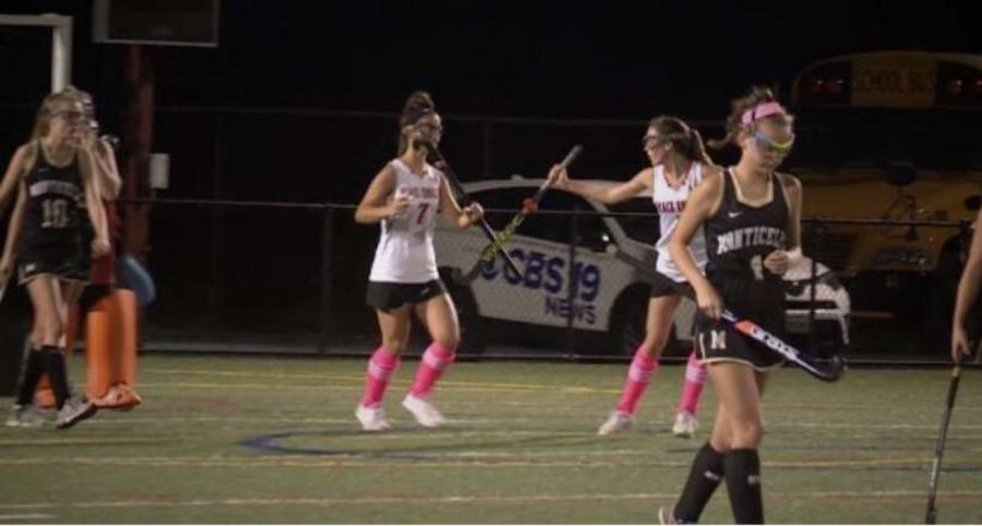 Field hockey players, Lucia Hoskins and Emmelia Kromkowski, celebrate after scoring a goal last season against Monticello. 