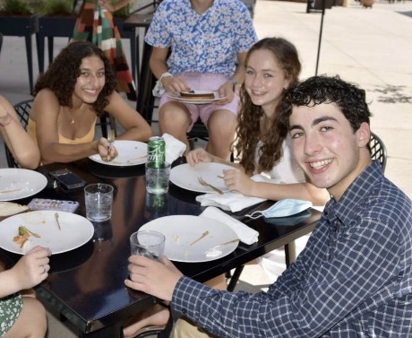 Jewish students (from left to right) Nava Khurgel, Eliza Jaffe, and Solly Golubouff-Schragger, sit at a Congregation Beth Israel event.