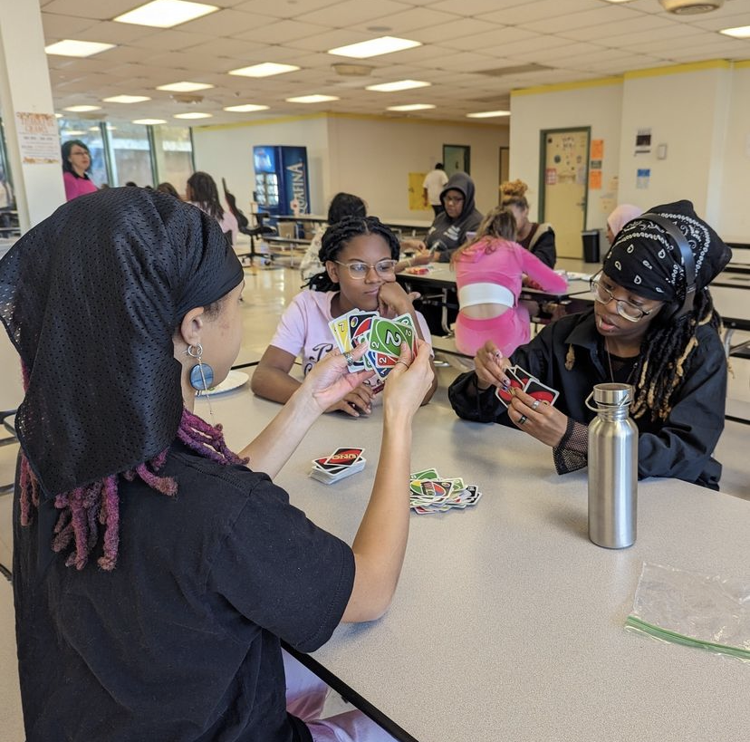 A group of students playing cards.