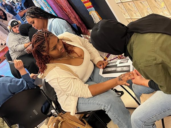 Students receiving henna tattoos