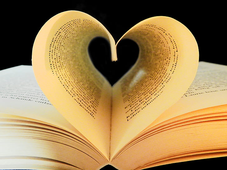 Book pages curled up to show a heart.