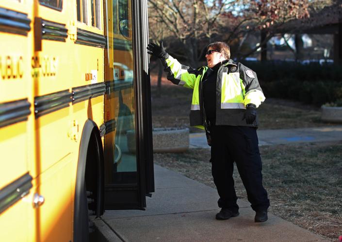 An SRO leading students off of the bus at CHS. Photo by the Daily Progress